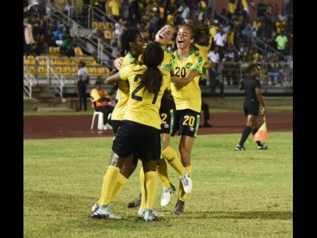 
Jamaican striker Khadija Shaw (left) is mobbed by teammates after bagging one of her two goals against Chile in their friendly international at the Montego Bay Sports Complex in St James on March 3. The Jamaicans won 3-2.  