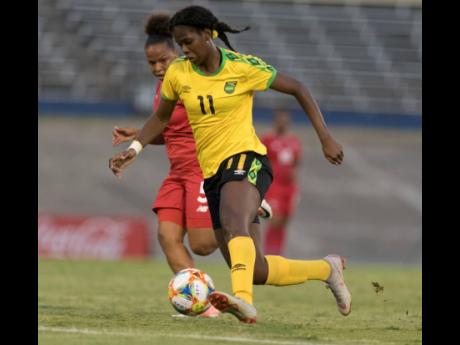 Jamaica's Khadija Shaw (front) dribbles away from Panama's Yomira Pinzon during their international friendly match played at the National Stadium in Kingston tonight.
