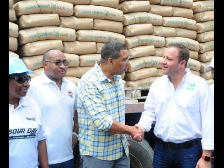 From left: Olivia Grange, minister of culture, gender, entertainment and sport; Major Clive Davis, director general of the Office of Disaster Preparedness and Emergency Management; Prime Minister Andrew Holness and Peter Donkersloot, general manager of Carib Cement, at the 2018 donation of 3,000 bags of cement to Labour Day and national disaster-recovery efforts. 