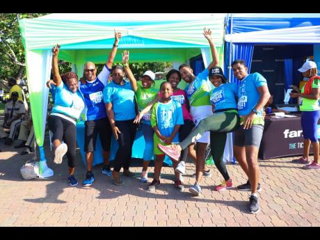 Members of team Sagicor Group pose by their tent in Emancipation Park.