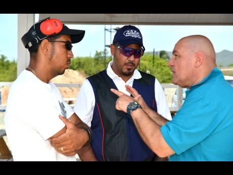 Italian skeet shooting coach Raffaele Bianco gives instruction to Shaun Barnes (left) and Christian Sasso at the Jamaica Skeet Club in Portmore, St Catherine recently during a training session ahead of the Pan American Games that will be held in Lima, Peru, in July. 