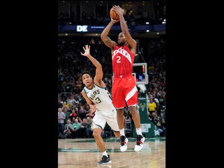 Toronto Raptors’ Kawhi Leonard (right) shoots in front of Milwaukee Bucks’ Malcolm Brogdon during the second half of Game 5 of the NBA Eastern Conference basketball play-off finals on Thursday, May 23, 2019, in Milwaukee. The Raptors won 105-99 to take a 3-2 lead in the series. 