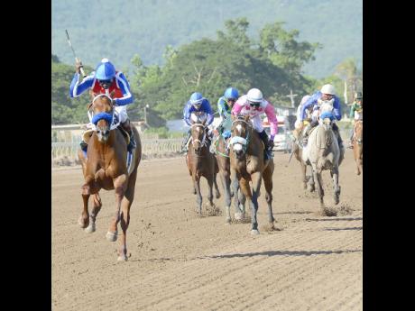 Supreme Soul (left), ridden by Shane Ellis, charges to victory in the Andrew H.B. Aguilar Memorial Cup at Caymanas Park on Saturday, November 8, 2018. 