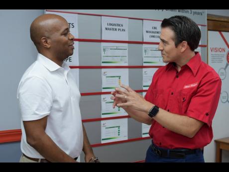 Ricardo Nuncio (right), managing director, Red Stripe, speaks with Stephen Dawkins, vice-president, Export and Logistics Committee, Jamaica Manufacturers’ and Exporters’ Association, at an export peer share hosted by the brewing company. 