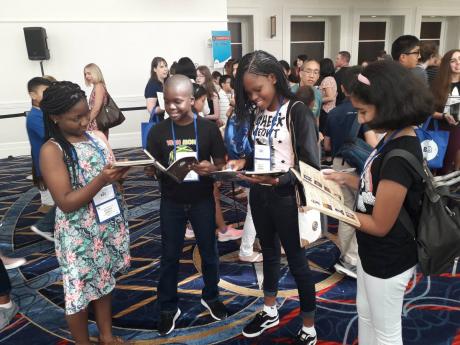 READY FOR THE SPELLDOWN
Darian Douglas (second left), The Gleaner’s Children’s Own Spelling Bee champion, and fellow finalists (from left) Ashleigh Jarrett, Rhonoya Anderson and Honey Advani review reading material during an interactive session ahead of today’s start of the Scripps National Spelling Bee competition in the United States.