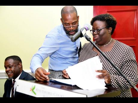 Chairman of Kingston Properties Garfield Sinclair consults with KPMG representative  Nadine Williams on the auditors report, at the company’s annual general meeting on Tuesday, May 28, 2019, held at Knutsford Court Hotel in New Kingston. 