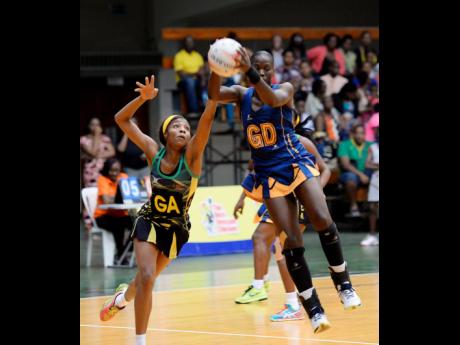 Jamaica goal attack Rebekah Robinson (left) tackles Barbados goal defence Rhe-Ann Niles for possession of the ball during the first quarter of their three-Test series at the National Arena on Monday, May 22, 2017.