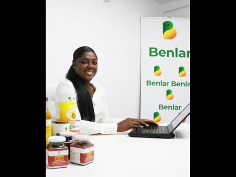 Benlar Foods CEO Craslyn Benjamin with products ready for export.