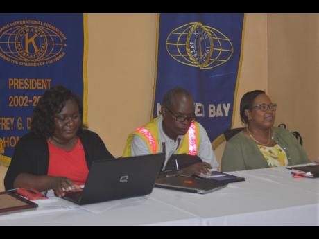 Kenute Hare (centre), director of the Road Safety Unit in the Ministry of Transport and Mining, sits at the head table during Thursday’s meeting of the Kiwanis Club of Montego Bay at Martina’s Juice Bar and Grill on Howard Cooke Boulevard in the western city. Also pictured are Camille Barrett (right), president of the Kiwanis Club of Montego Bay, and club secretary Carlene Moore.