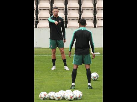 Portugal’s Cristiano Ronaldo gestures during a training session at the Bessa stadium in Porto, Portugal, yesterday. Portugal will face Switzerland today in a UEFA Nations League semi-final. 