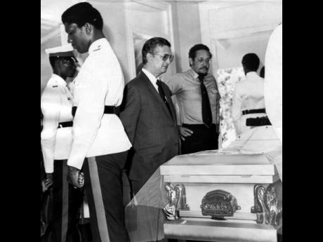 In this August 15, 1977, Gleaner file photo, then Opposition Leader Edward Seaga takes a final look at the body of  Sir Alexander Bustamante at the funeral for Jamaica’s first prime minister.