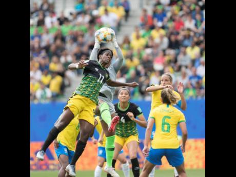 Jamaica’s Khadija Shaw (left) is denied a header by Brazil goalkeeper Babara. 