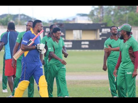 Captain Krishmar Santokie (third left) is congratulated by teammates following Clarendon’s win over St Elizabeth in the Jamaica Cricket Association T20 Bashment tournament at Chedwin Park, St Catherine, at the weekend. 