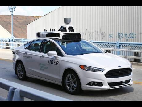 A self-driving Ford Fusion hybrid car is seen being test-driven on August 18, 2016, in Pittsburgh.