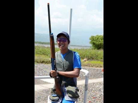 Cameron Phang Sang is all smiles after winning the National Commercial Bank Junior Sporting Clays Open Championship at the Jamaica Skeet Club range in Portmore, St Catherine, on Sunday. 
