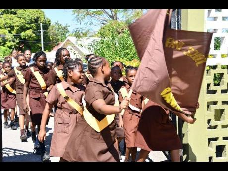 Members of the Catherine Hall Primary, Infant and Special Education School Brownies march on June 4.