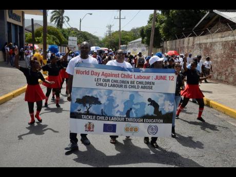 Zavia Mayne (left), state minister in the Ministry of Labour and Social Security (MLSS), Cheryl Davis Ivey (centre) and Sasha Deer-Gordon (right), director of child labour, MLSS, lead the St Michael Steppers Band during a road march on Wednesday against child labour. The march started at the MLSS on North Street and ended at the St Williams Grant Park, downtown Kingston. 