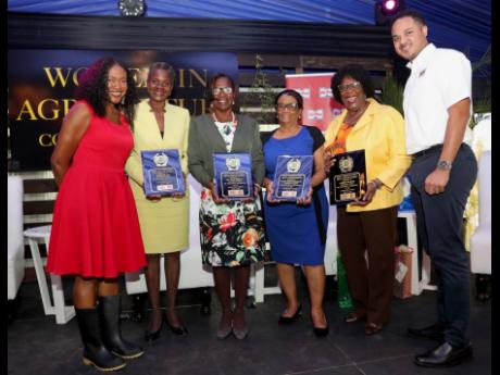 Joan Taylor (left), presenter at the Jamaica Agricultural Society (JAS) Women in Agriculture conference, and Dayne Patterson (right), business develpment manager, Hi-Pro, pose with some of the Women in Agriculture awardees who were honoured by the JAS on Wednesday. They are (from second left) Chef Mazie Miller, Dr Dian Medley, Paulette Lyons Dodd, and Jasmin Holness.