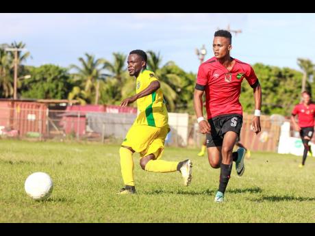 Renior Elliott (left) of Vere FC battles with Downs FC’s Romario Witter during their JFF All-Island Confederation Play-Offs encounter at the Wembley Centre of Excellence in Hayes, Clarendon, on Sunday, June 3. 