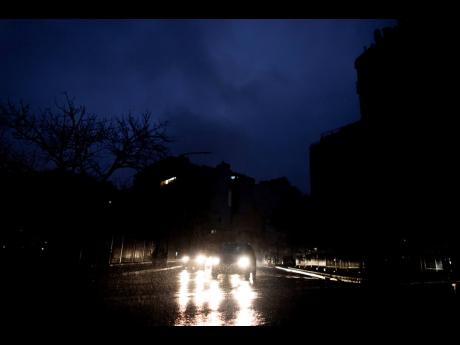 Cars drive through an unlit street during a blackout in Buenos Aires, Argentina, Sunday, June. 16, 2019. A massive blackout left tens of millions of people without electricity in Argentina, Uruguay and Paraguay on Sunday in what the Argentine president called an “unprecedented” failure in the countries’ power grid. (AP Photo/Tomas F. Cuesta)