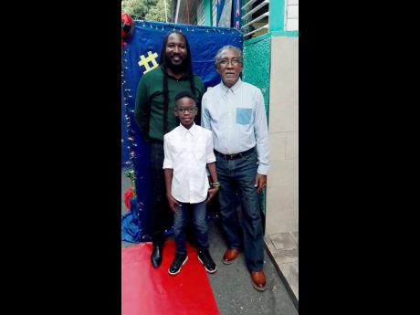 From left: Barrington Pettigrew Jr with his father, Barrington Sr, and son, Jahbari, pose for a family photo on the red carpet at Vaz Preparatory School’s ‘It’s a King Affair’.