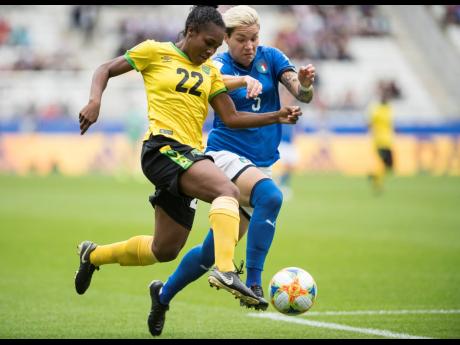 Jamaica’s Mireya Grey (left) is tackled by Elena Linari of Italy as she dribbles to goal during the teams’ second Group C match in the FIFA Women’s World Cup at Stade Auguste-Delaune in Reims, France, on Friday, June 14. The Reggae Girlz lost 5-0. 