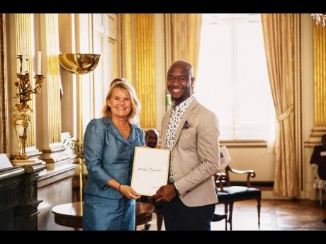 Head of Nation Branding at the Ministry of Foreign Affairs of Sweden, Gabriella Augustsson (left), presents the Global Swede Award to Sanjay Thompson on May 21 at Sweden’s Ministry of Foreign Affairs. 