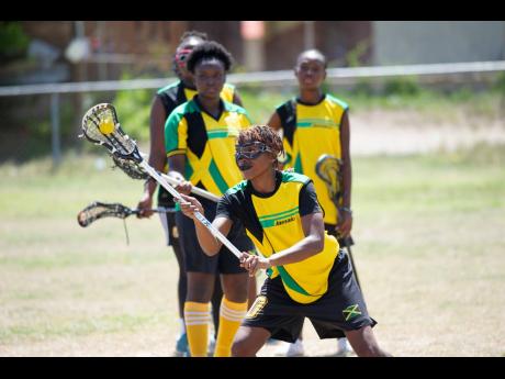 Alicia Thaxter (front) engages in training drills with her teammates at the Wolmer’s Preparatory School playing field on Saturday, June 8. Jamaica’s Under-19 Lacrosse team is preparing for the Federation of International Lacrosse Women’s Under-19 Championships in Ontario, Canada from August 1-10.  