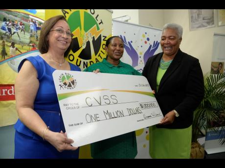 Usain Bolt Foundation board member Maureen Samms Vaughan (left) presents a cheque to Council of Voluntary Social Service (CVSS) chief executive officer, Winsome Wilkins (right), and CVSS youth sector chairperson, Tanketa Chance-Wilson, during the media launch of the CVSS Summer Games at the Jamaica Olympic Association headquarters on Wednesday.