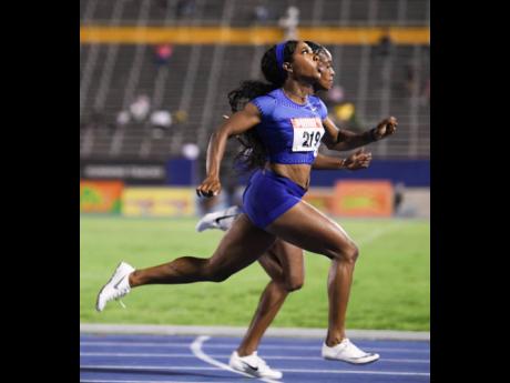 Elaine Thompson (background) edges Shelly-Ann Fraser-Pryce to the line in the women’s 100m final at the Supreme Ventures/JAAA National Senior Championships at the National Stadium on Friday night. Both athletes were clocked at 10.73 seconds. 