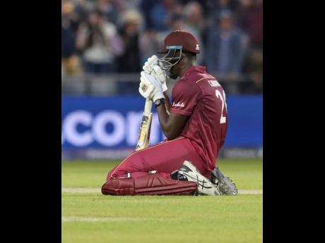 
West Indies’ Carlos Brathwaite reacts after losing the Cricket World Cup match against New Zealand at Old Trafford in Manchester, England, yesterday.