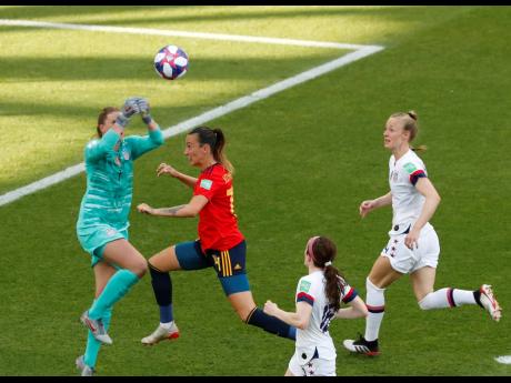 United States goalkeeper Alyssa Naeher (left) makes a save in front of Spain’s Virginia Torrecilla (second left) during the FIFA Women’s World Cup round-of-16 match between the sides at Stade Auguste-Delaune in Reims, France, yesterday. 