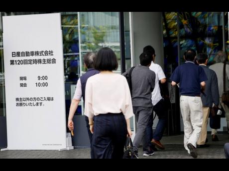 Shareholders enter a conference hall to attend Nissan’s general meeting of shareholders in Yokohama, near Tokyo, Tuesday, June 25, 2019.