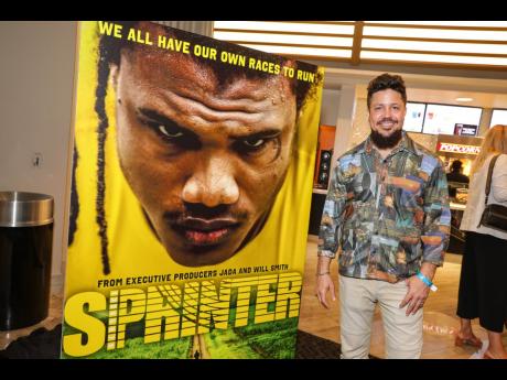 Writer and director, Storm Saulter, poses alongside a banner of his latest film, SPRINTER, while at the film’s US premiere at the Grove Theater in Los Angeles California in April. SPRINTER opens locally next Wednesday.