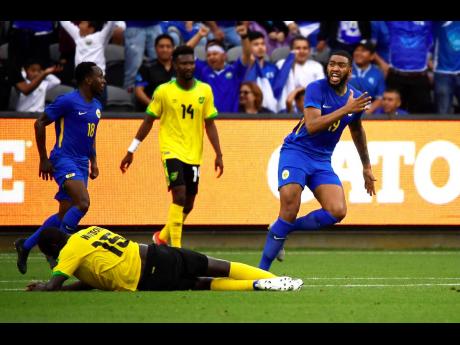 Curaçao forward Jafar Arias (right) celebrates a goal by Jurien Gaari as Jamaica midfielder Je-Vaughn Watson lies on the ground during the second half of a Concacaf Gold Cup match on Tuesday in Los Angeles. The game ended 1-1. 
