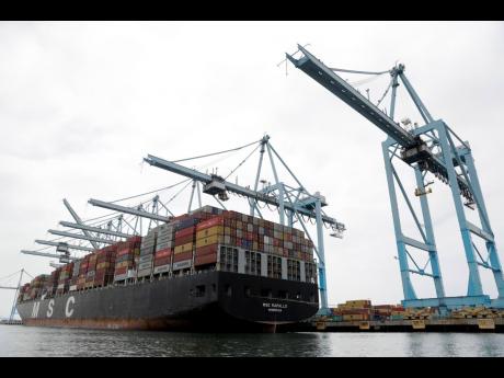 In this June 19, 2019, file photo a cargo ship is docked at the Port of Los Angeles in Los Angeles.