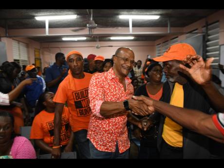 Central Manchester Member of Parliament Peter Bunting (centre) is greeted by supporters in the Knockpatrick division as he arrives at May Day High School earlier this month. Bunting will challenge Dr Peter Phillips for the leadership of the People’s National Party. Ricardo Makyn/Chief Photo Editor