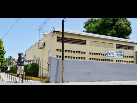 
An elderly man exits  the  Rollington Town Health Centre , in St 
Andrew.