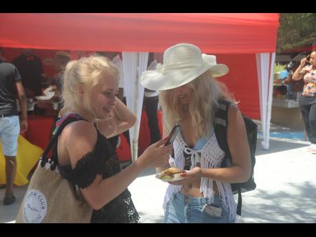 Swedish reggae fan Amanda Elfstrand (left) and her companion enjoying the ambience at Mawnin Medz.