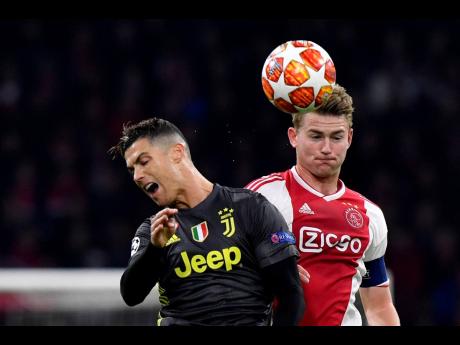 In this Wednesday, April 10, 2019 file photo, Ajax’s Matthijs de Ligt (right) fights for the ball with Juventus’ Cristiano Ronaldo during the Champions League quarter-final first-leg match between the two teams at the Johan Cruyff Arena in Amsterdam, the Netherlands. Defender Matthijs De Ligt has signed with Juventus.