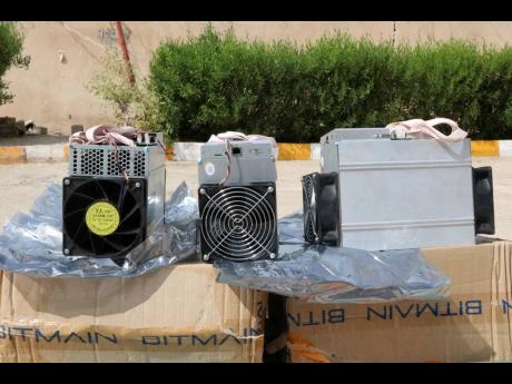 This undated photo provided by the Police News Agency shows boxes of machinery used in Bitcoin ‘mining’ operations that were confiscated by police in Nazarabad, Iran.
