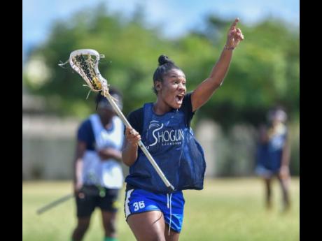 Shanice Thompson shouts instructions to a teammate as she runs towards the D in a training session for the national under-19 women’s lacrosse team at Wolmer’s High School for Girls earlier this year.