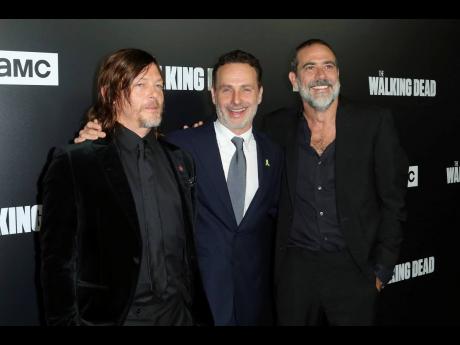 In this 2018 file photo, from left to right, Norman Reedus, Andrew Lincoln and Jeffrey Dean Morgan arrive at the LA Premiere of Season 9 of their show “The Walking Dead”  in Los Angeles. The network behind the show that’s become synonymous with Georgia says it will “reevaluate” its activity in the state if a new abortion law goes into effect. The Walking Dead’s success has drawn steady streams of tourists to the Georgia towns where it has been filmed. 