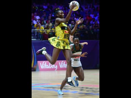 Jamaica’s Jodian Ward (front) catches the ball as South Africa’s Bongiwe Msomi looks on during their Vitality Netball World Cup match at the M&S Bank Arena in Liverpool, England, on Sunday, July 14. 