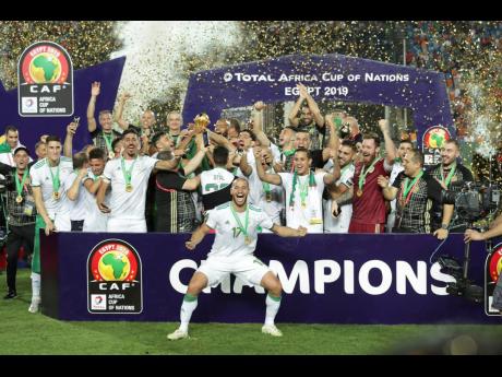 Algerian players celebrate after winning the African Cup of Nations at the Cairo International Stadium in Cairo, Egypt, yesterday. 