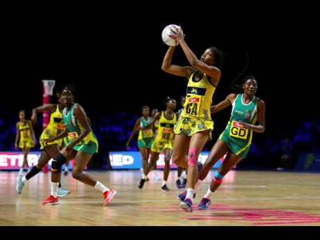 Jamaica’s Rebekah Robinson (second left) takes possession of the ball while Zimbabwe goal defence Felisitus Kwangwa (right) tracks back, and Adelaide Muskwe (left) looks on during their Vitality Netball World Cup match at the M&S Bank Arena in Liverpool, England, yesterday. 