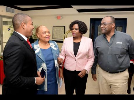 Minister of State in the Ministry of Industry, Commerce, Agriculture, and Fisheries, Floyd Green (left), is in discussion with (from second left): Executive Director of Jamaica Business Development Corporation, Valerie Veira; Permanent Secretary in the Ministry of Tourism, Jennifer Griffith; and Director of Tourism, Donovan White, during the fifth staging of the Christmas in July trade show at The Jamaica Pegasus hotel in New Kingston on July 18.
