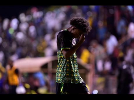 Jamaica Under-23 footballer Ricardo Thomas hangs his head in shame after the team’s failure to advance to the next round of Olympic football qualifying. 