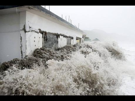 Ferocious waves crash violently against an abandoned house in Caribbean Terrace in St Andrew as Hurricane Sandy approached the island in October 2012.