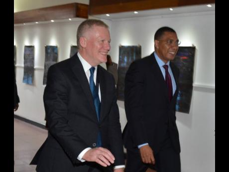 Prime Minister Andrew Holness (right) walks with Michael Lodge, secretary general of the International Seabed Authority, at a special session of the 25th assembly of the International Seabed Authority at the Jamaica Conference Centre yesterday to commemorate ISA’s 25th anniversary.